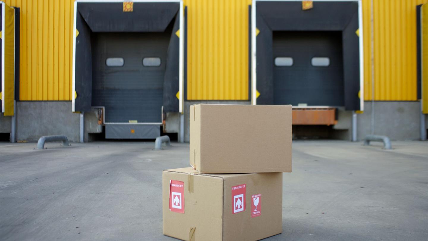 Cartons staged beside warehouse loading docks