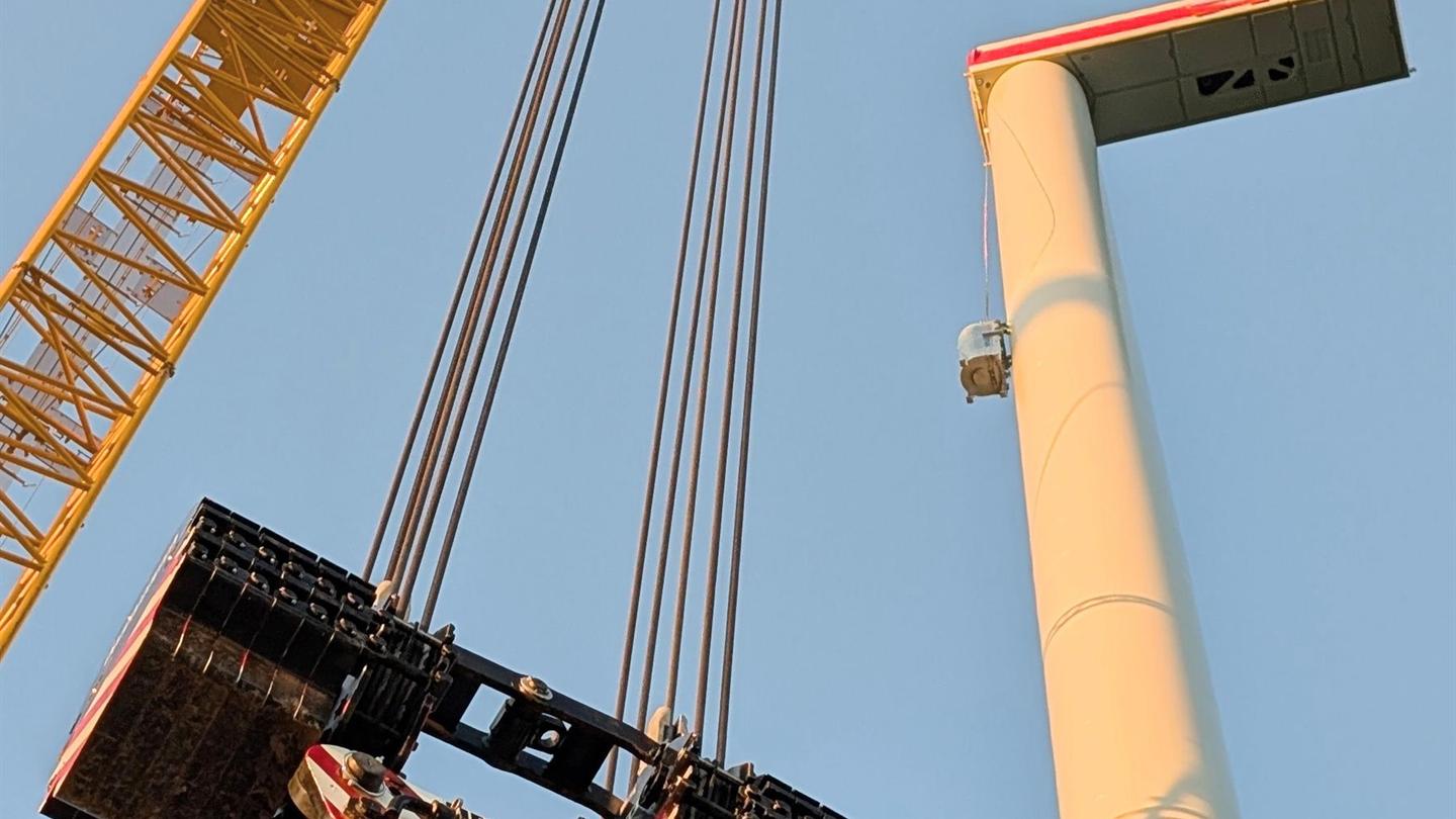 Crane lifting an oversized wind turbine component