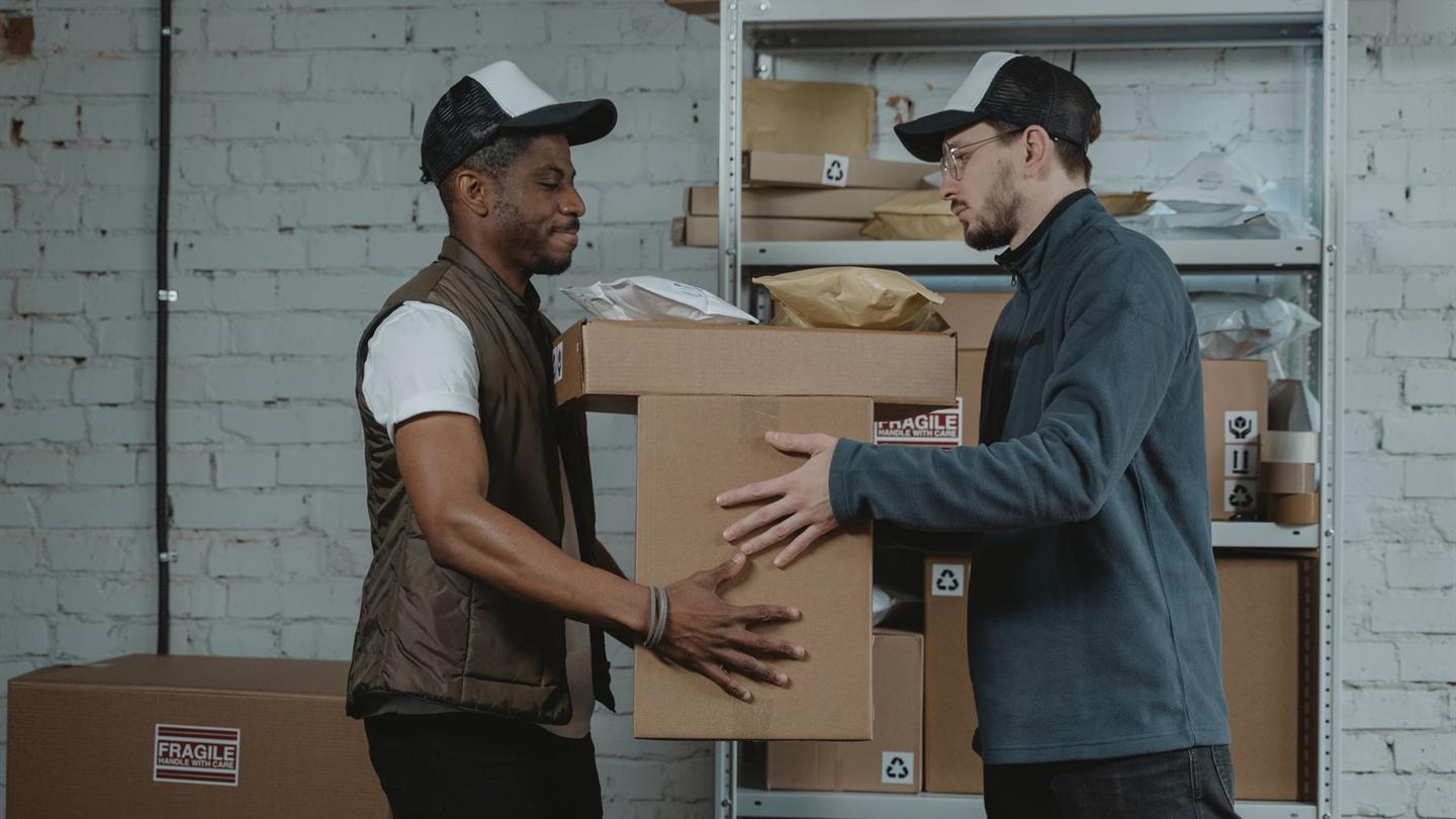 Delivery worker handing a package to a recipient