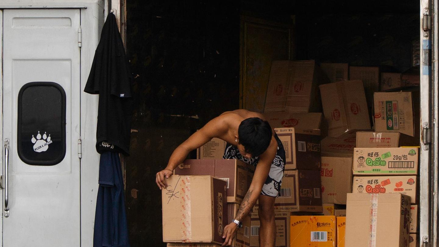 Worker organizing cargo inside a delivery truck