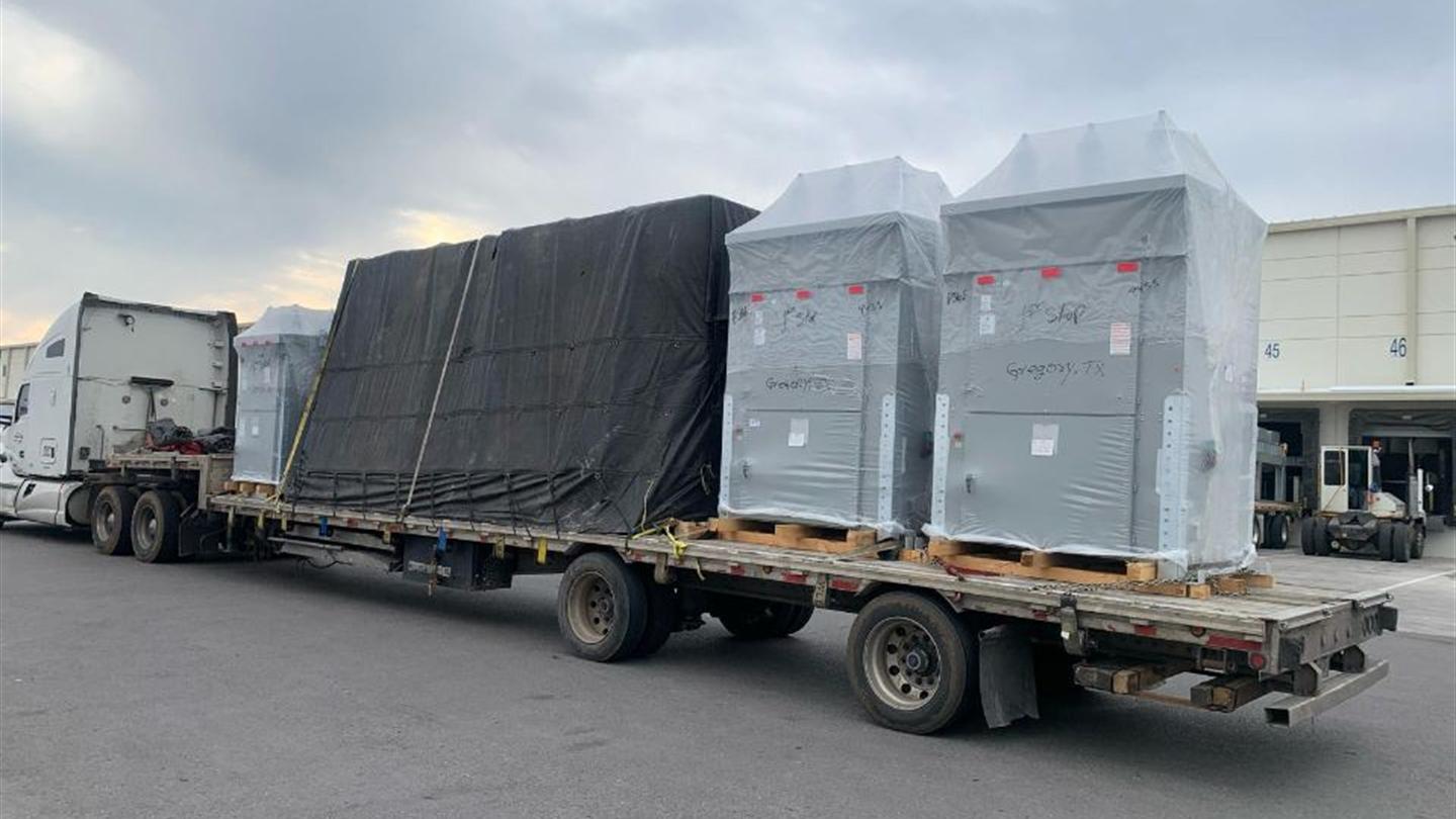 Crated cargo strapped on a flatbed trailer
