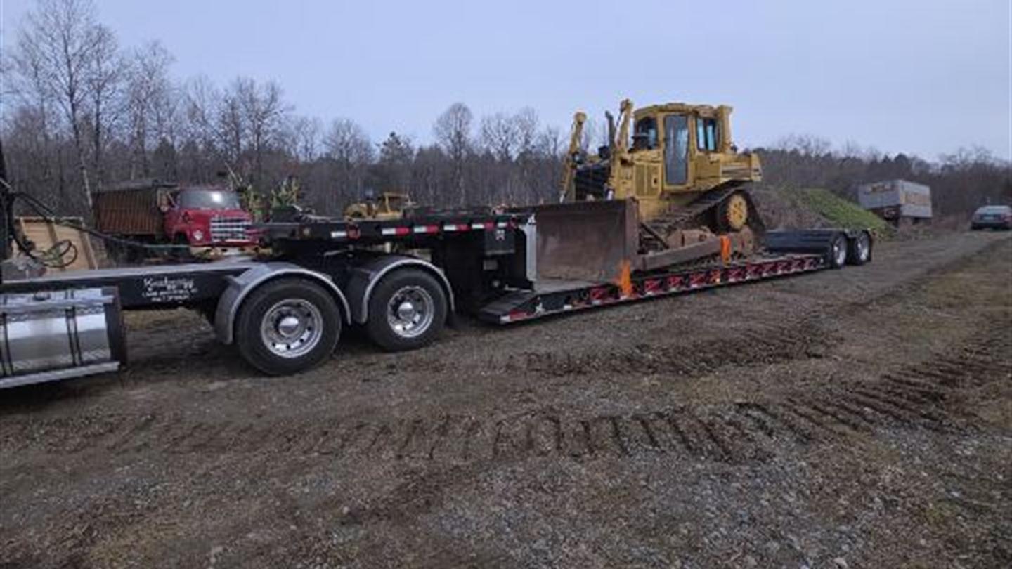 Dozer loaded on a lowboy trailer in the field