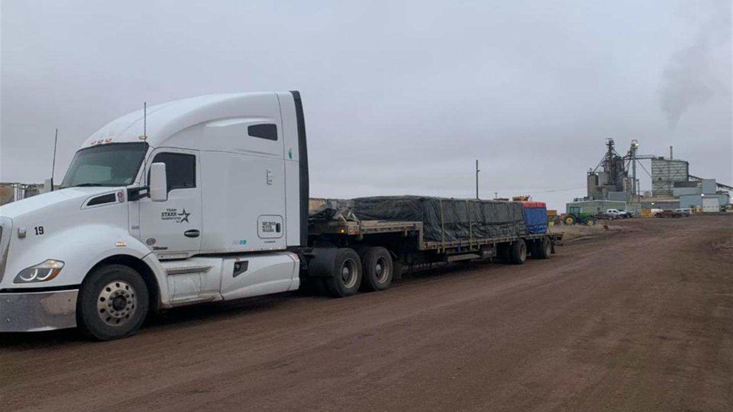 Step deck trailer en route on an open highway