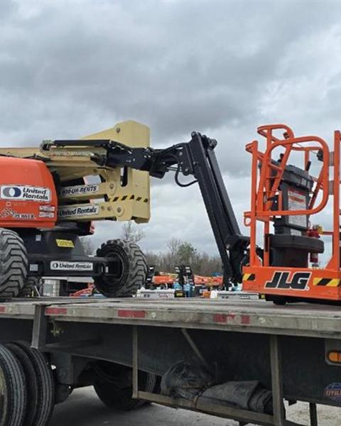 Boom lift and scissor lifts secured on a flatbed
