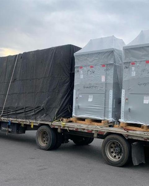 Crated cargo strapped on a flatbed trailer
