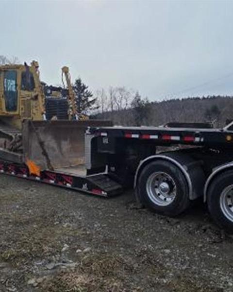 Wheel loader on an RGN trailer on a rural route