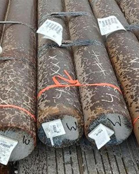 Bundled steel pipe prepared for flatbed transport