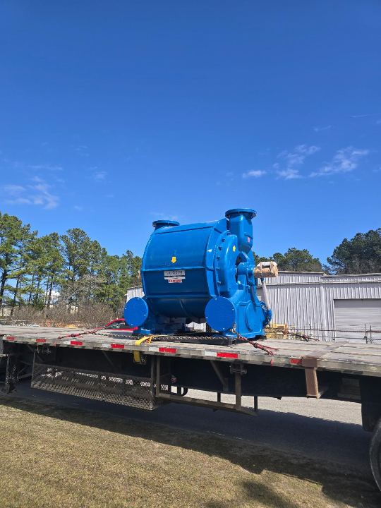 Industrial machinery strapped to a flatbed trailer