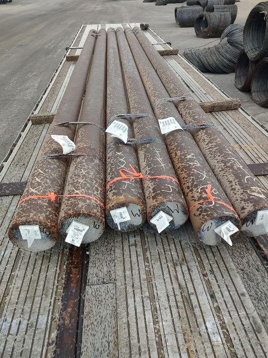 Bundled steel pipe prepared for flatbed transport