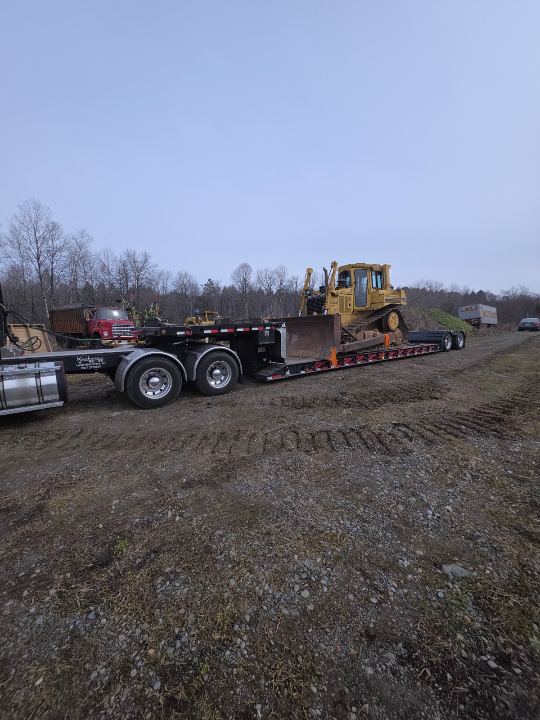 Dozer loaded on a lowboy trailer in the field