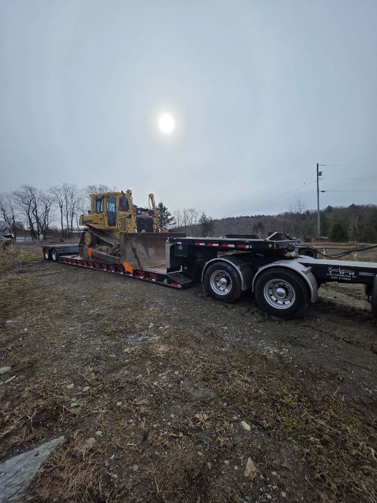 Wheel loader on an RGN trailer on a rural route