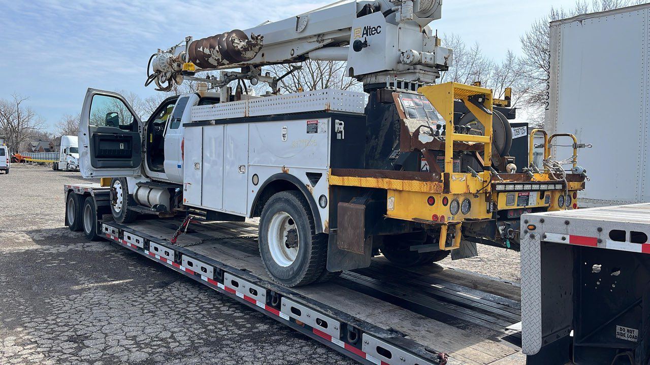 Utility bucket truck loaded for transport