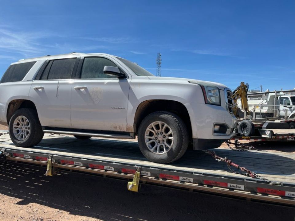 White SUV positioned for vehicle transport