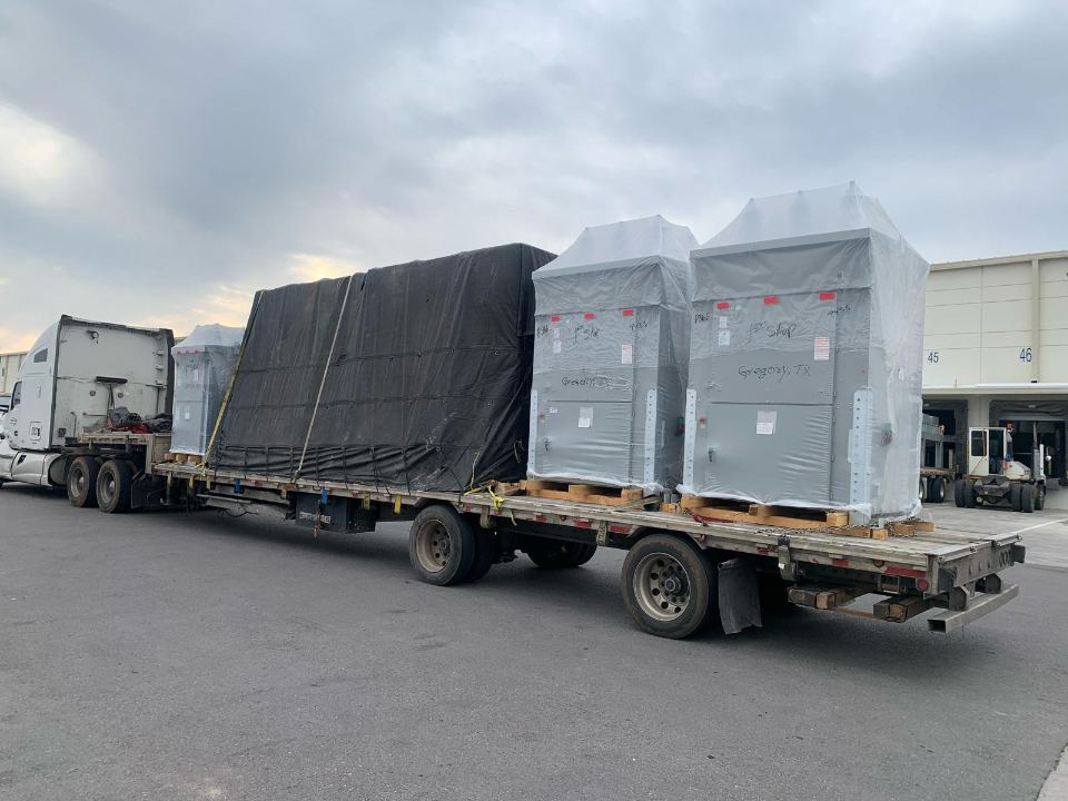 Crated cargo strapped on a flatbed trailer