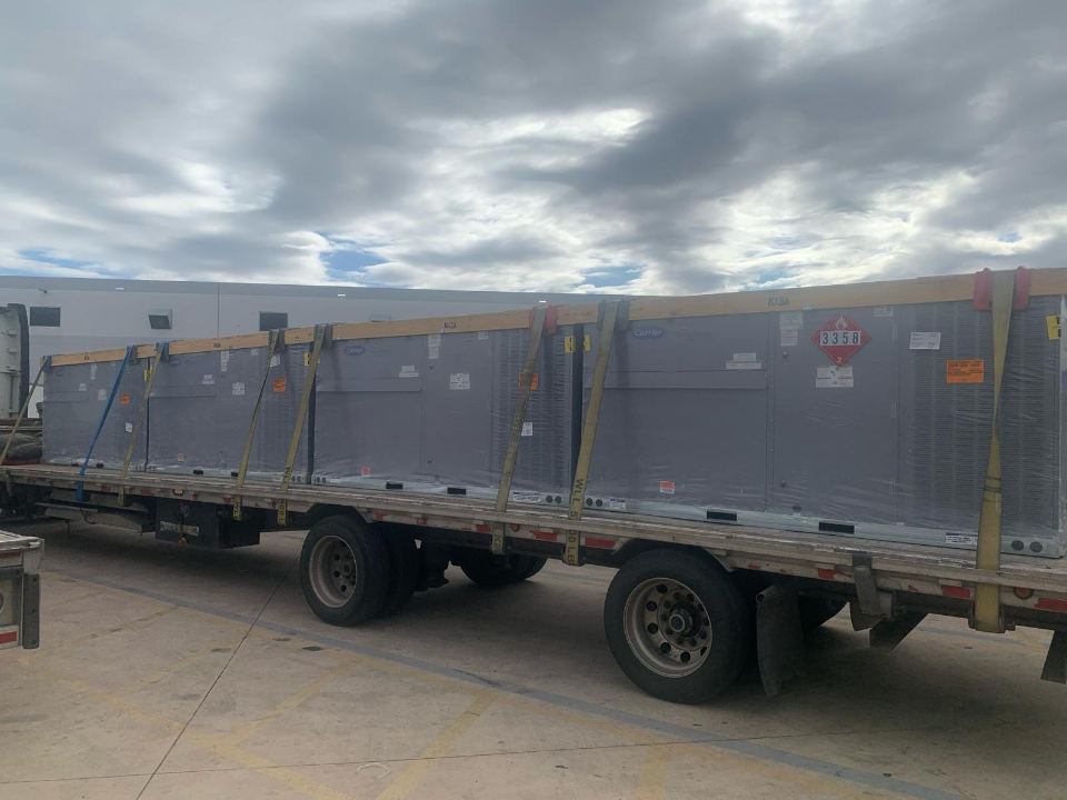 Wrapped commercial units strapped to a flatbed