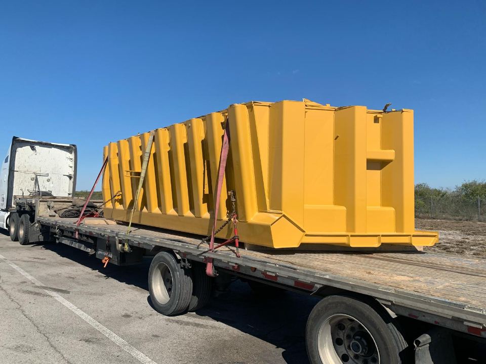 Steel hopper bins loaded on a flatbed trailer