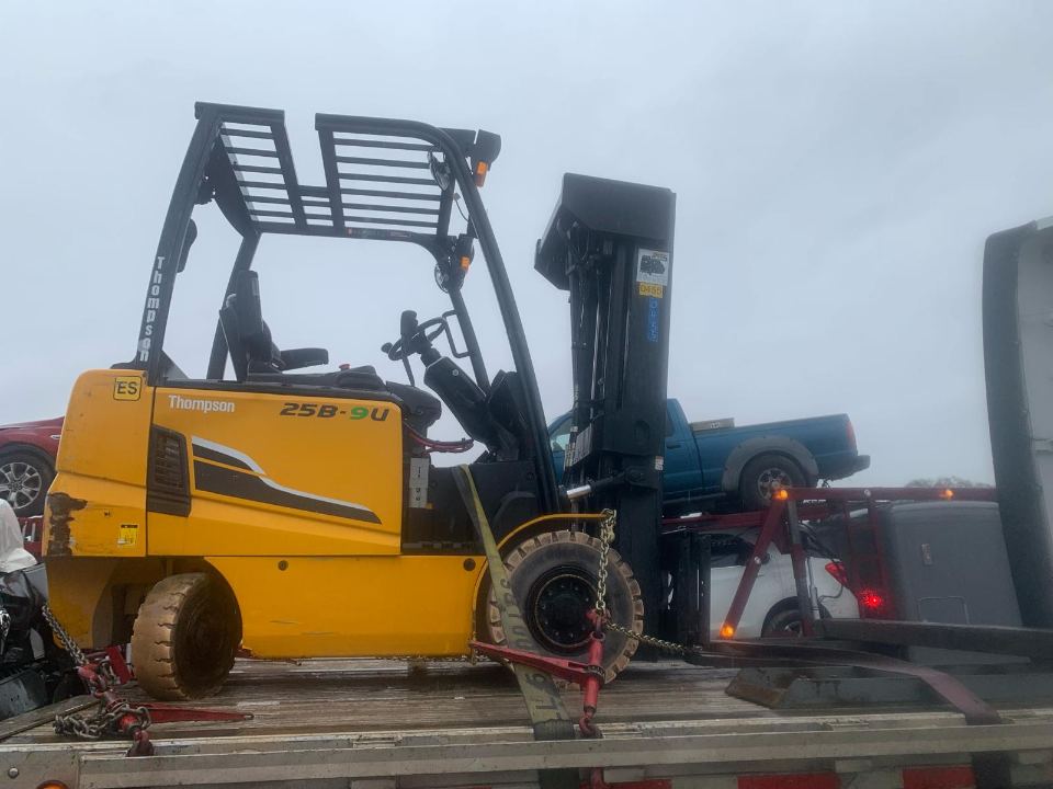 Forklift being positioned for equipment transport