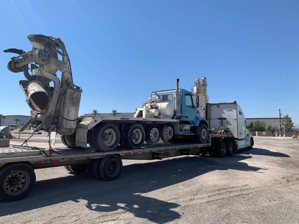 Salvage truck cab transported on a lowboy trailer