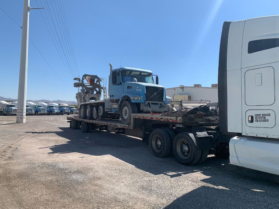 Commercial truck secured on a flatbed trailer