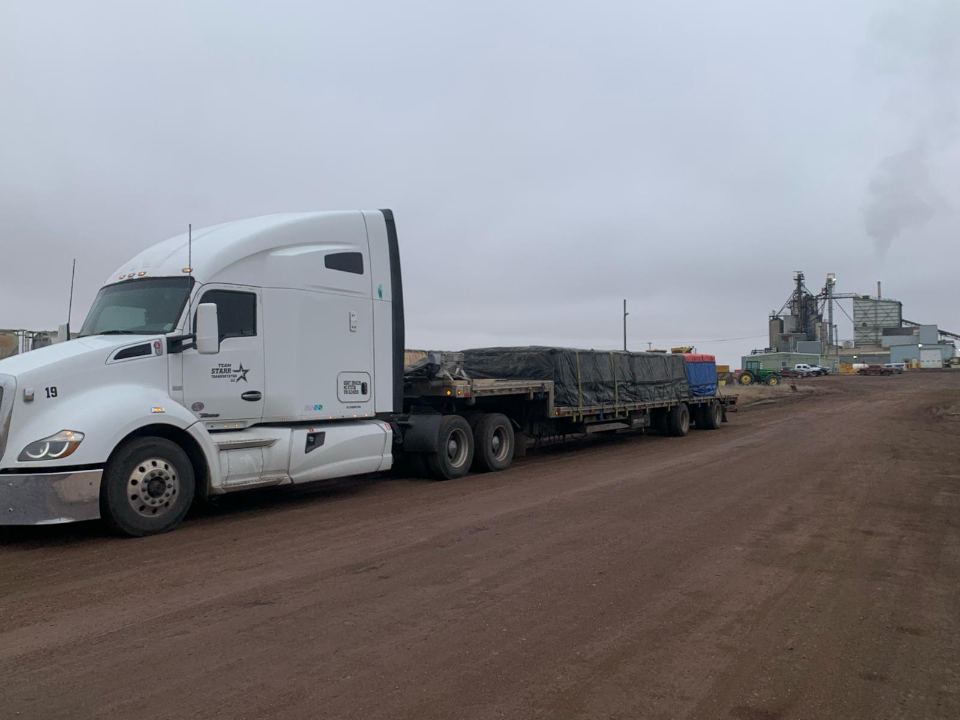 Step deck trailer en route on an open highway