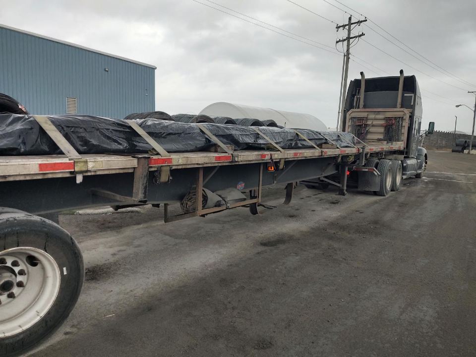 Tarped flatbed load at a loading dock